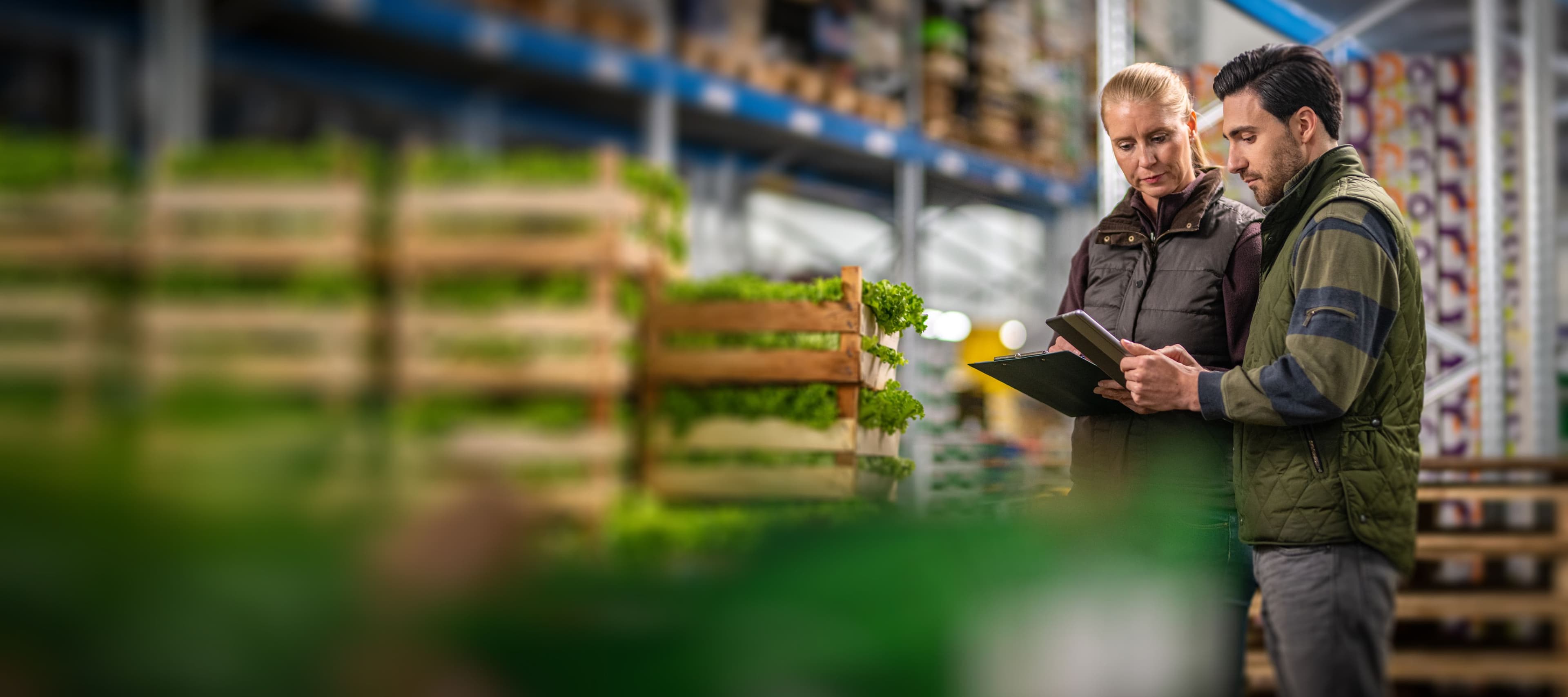 Man and woman looking at an ipad in a warehouse