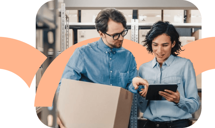 Two people looking at a tablet in a warehouse