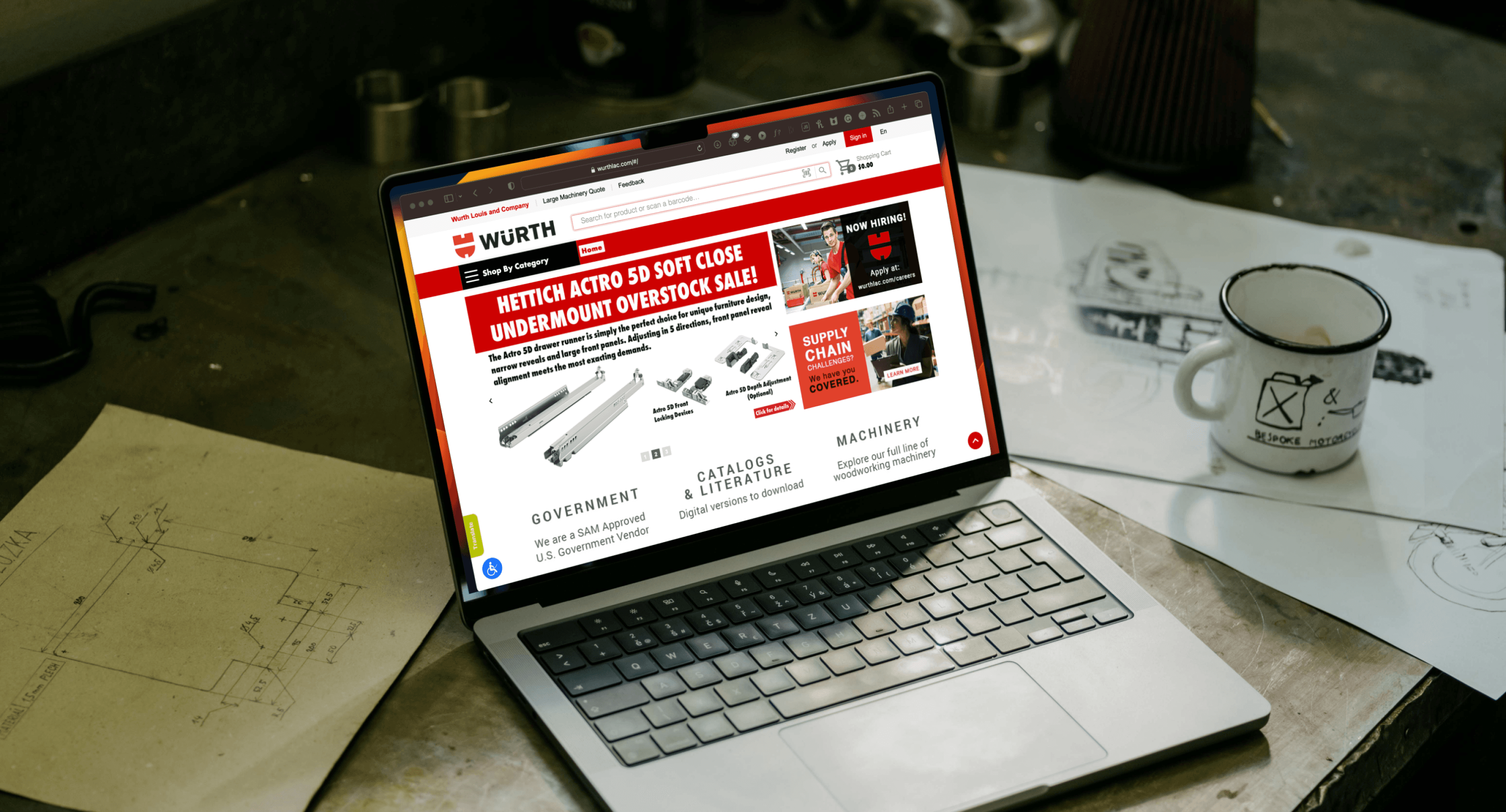 a laptop displaying the Würth website, on a workshop table